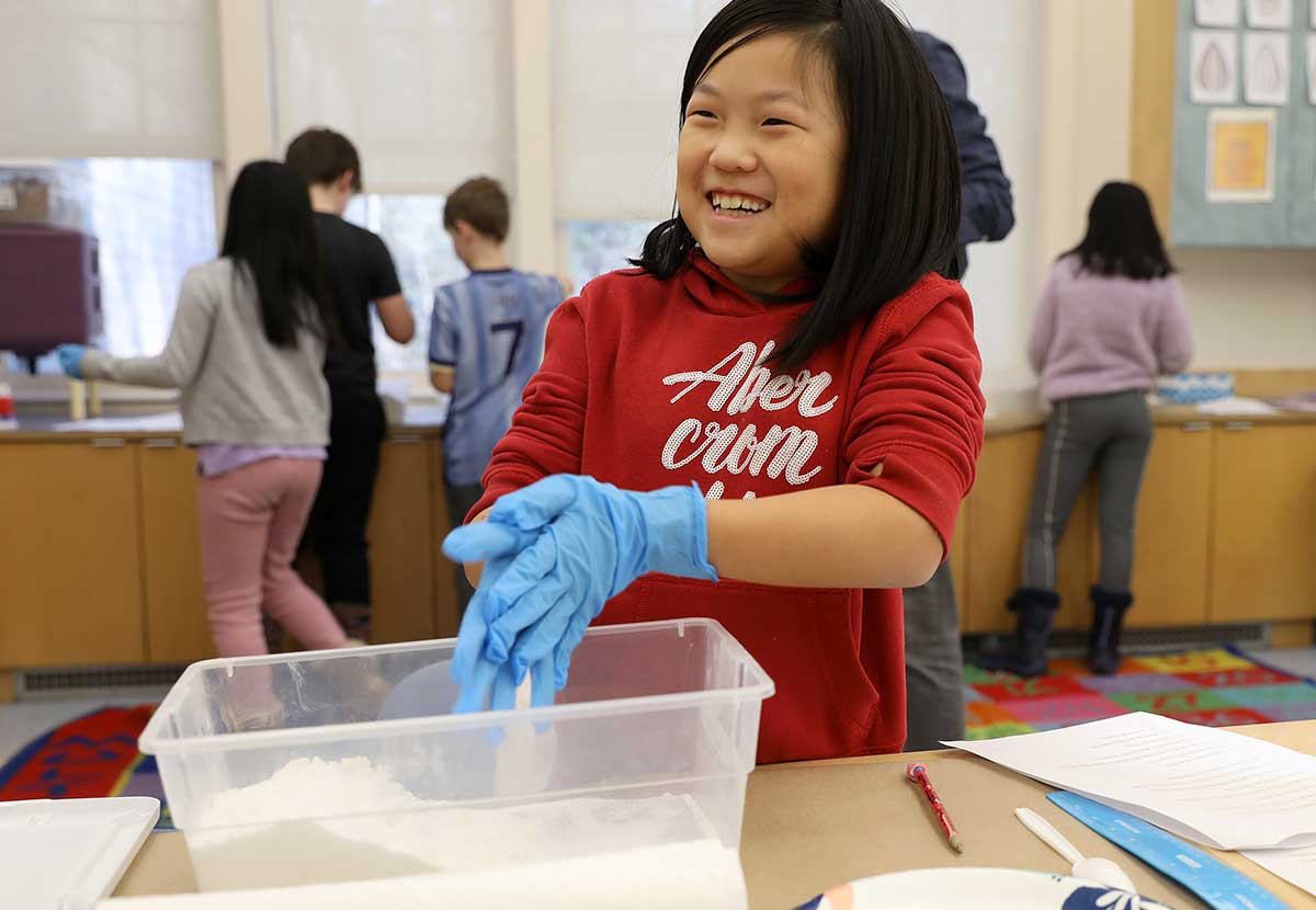 A girl smiles in science class