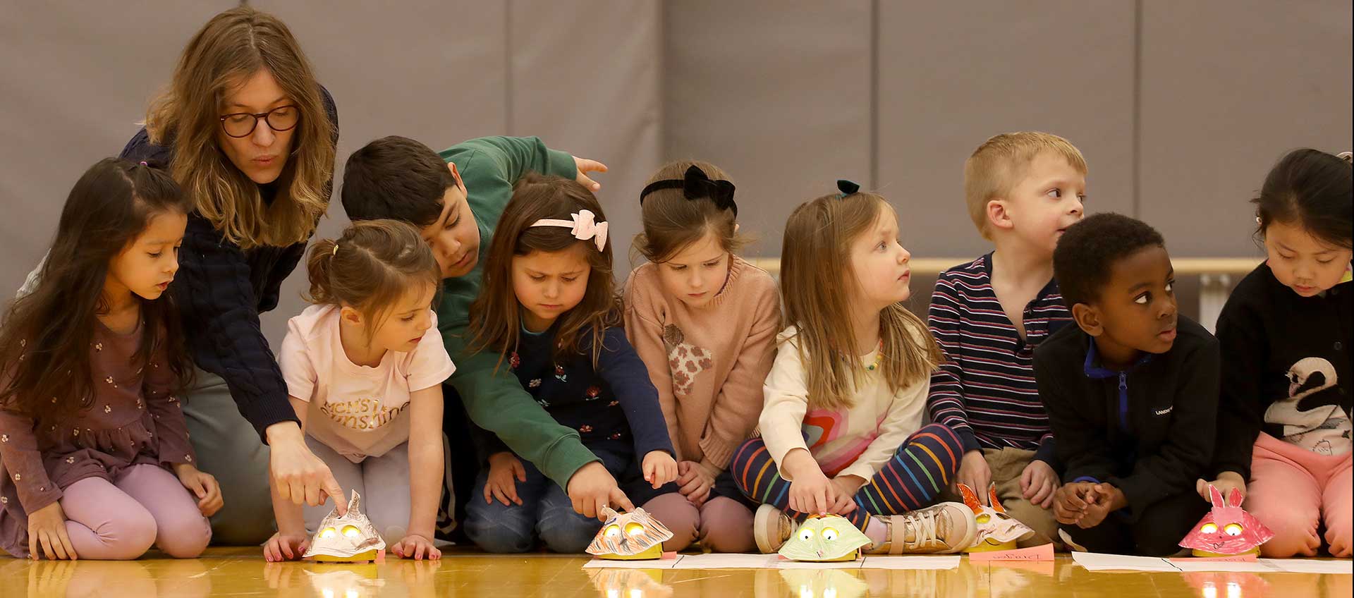 BDS innovation coach with pre-k students and their racing Bee-Bots