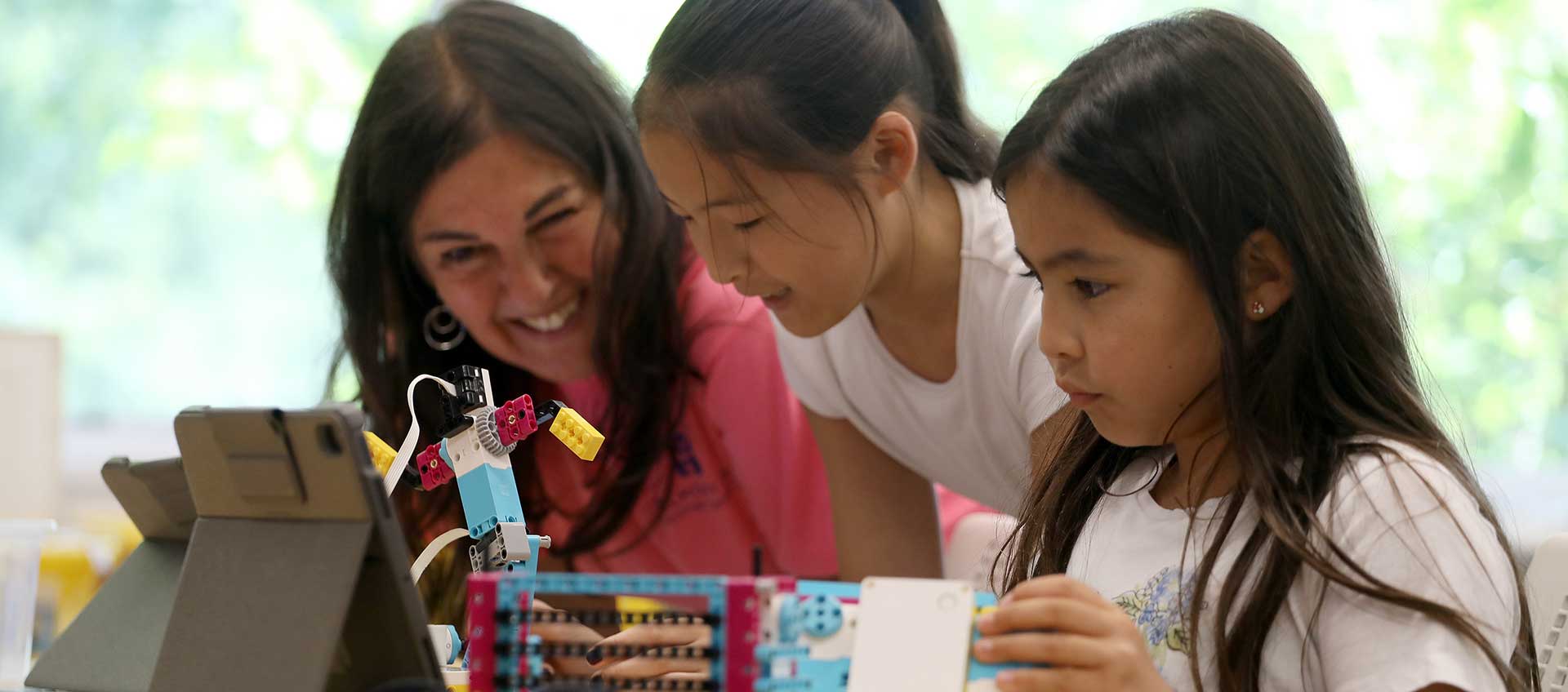 A counselor and campers at LEGO Robotics camp