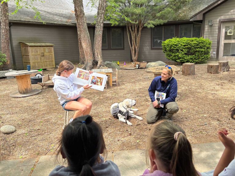 Olivia Garrity '24 with Officer Hankins and Watson, her community resource dog